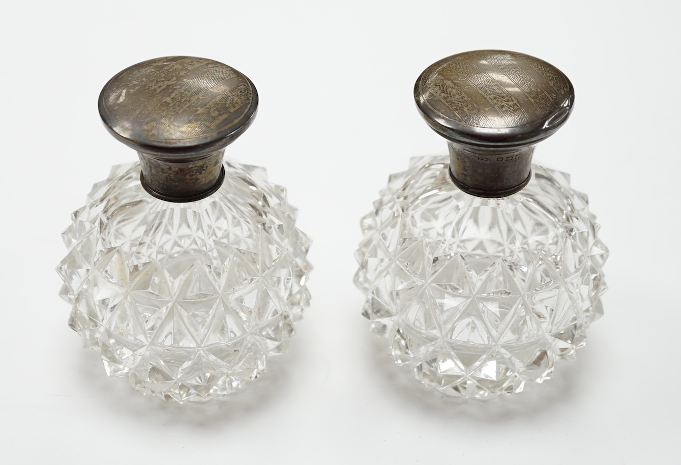 A pair of silver mounted scent bottles, 10cm